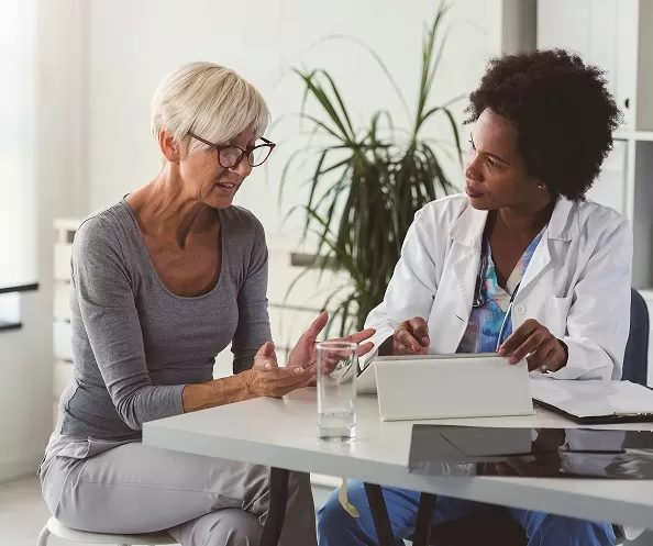 Woman speaking with doctor.